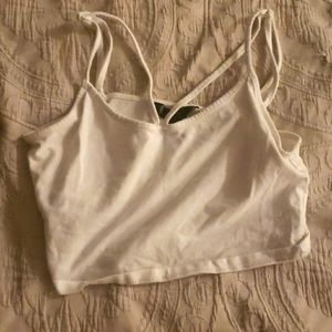 a white tank top and cropped
